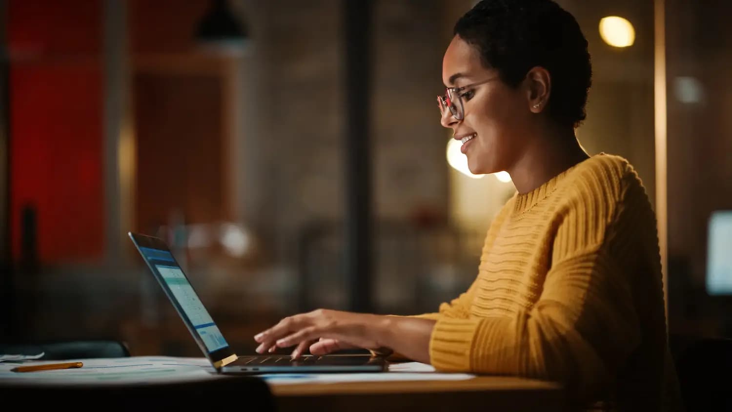 Jovem desenvolvedor multiétnico trabalhando em um laptop em ambiente de escritório criativo. A gerente de projetos da Beautiful Diverse Latin Female está desenvolvendo dados e agendando um projeto.